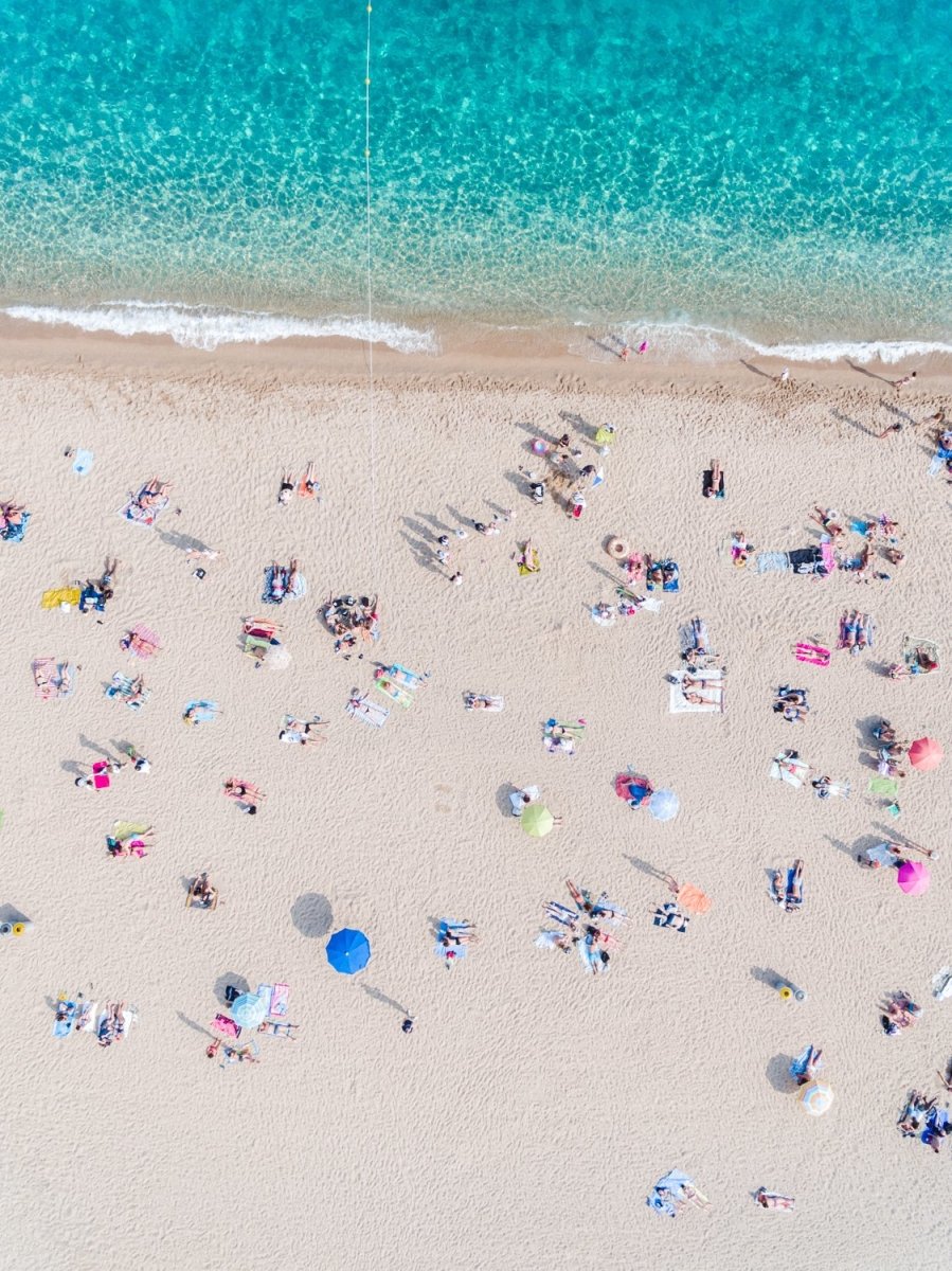 Busy beach day in Lloret de Mar during summer from aerial point