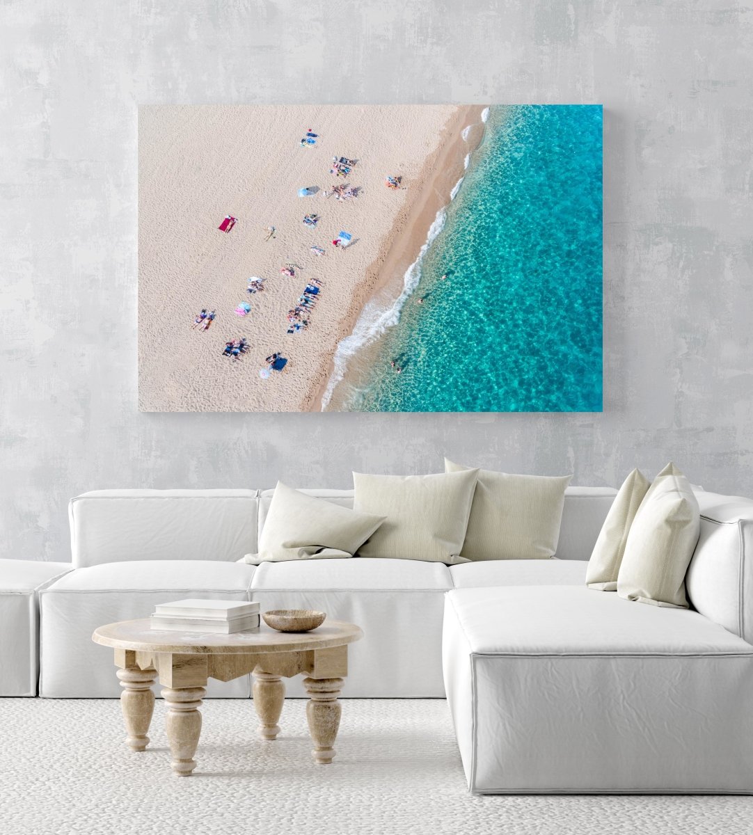 Simplistic aerial of blue ocean and people sunbathing in Costa Brava in an acrylic/perspex frame