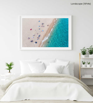 Simplistic aerial of blue ocean and people sunbathing in Costa Brava in a white fine art frame