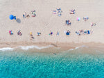 Lines of people tanning on beach in Spain from aerial view