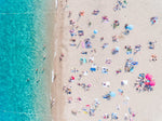 Topdown view of people lying on beach with bright blue water in Costa Brava