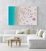 Topdown view of people lying on beach with bright blue water in Costa Brava in a white fine art frame
