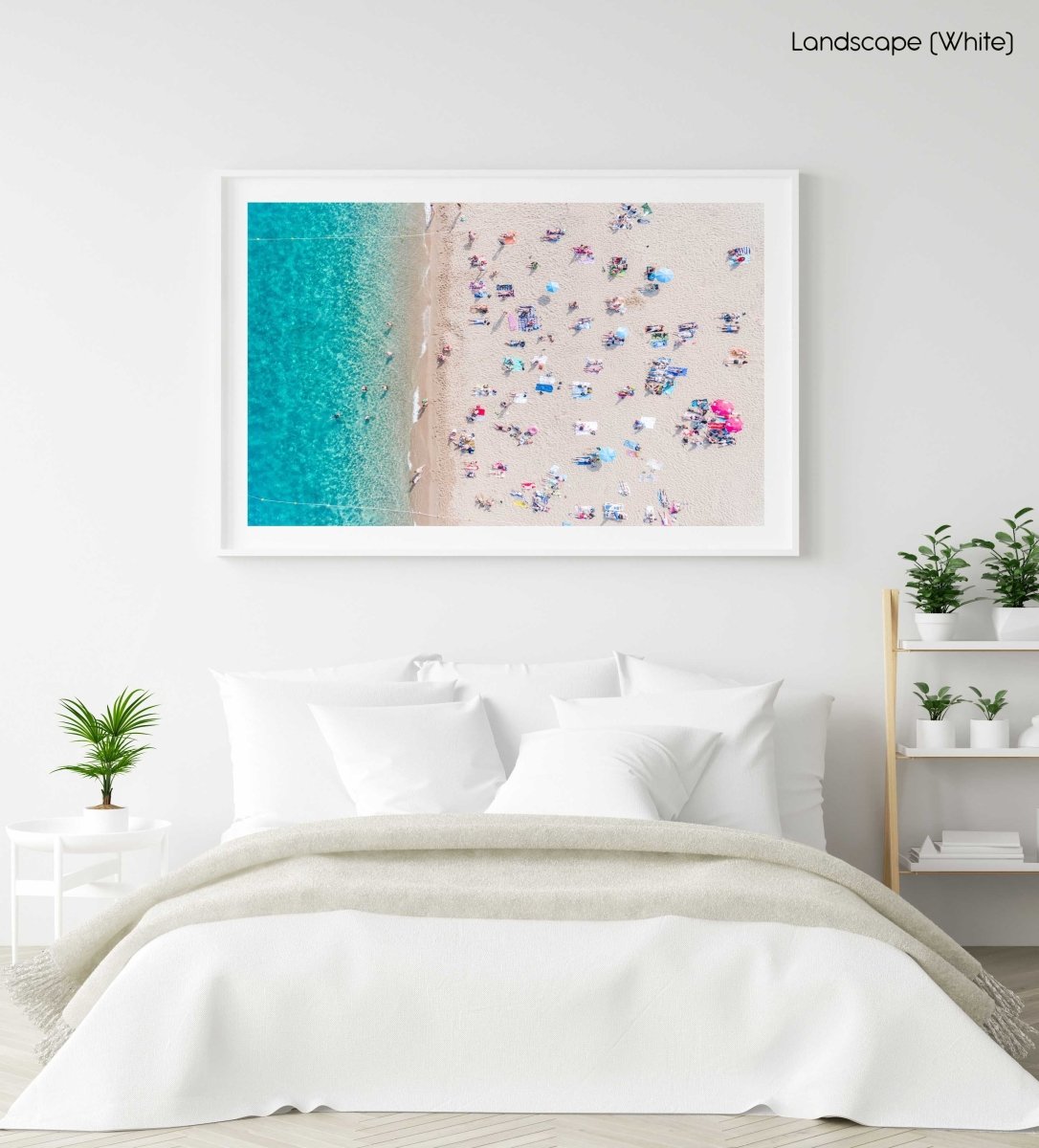Topdown view of people lying on beach with bright blue water in Costa Brava in a white fine art frame