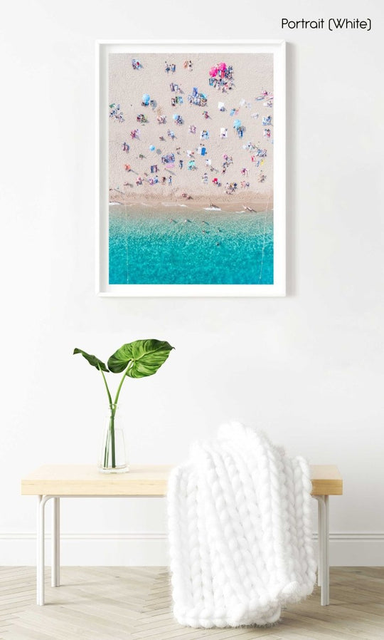 Topdown view of people lying on beach with bright blue water in Costa Brava in a white fine art frame