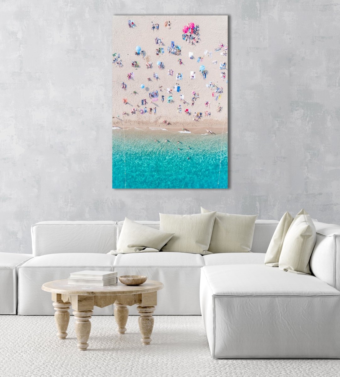 Topdown view of people lying on beach with bright blue water in Costa Brava in a natural fine art frame