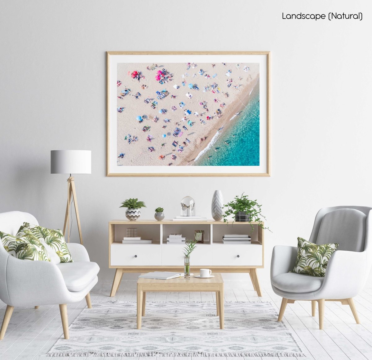 Aerial of people lying in the sun on the beach in a natural fine art frame