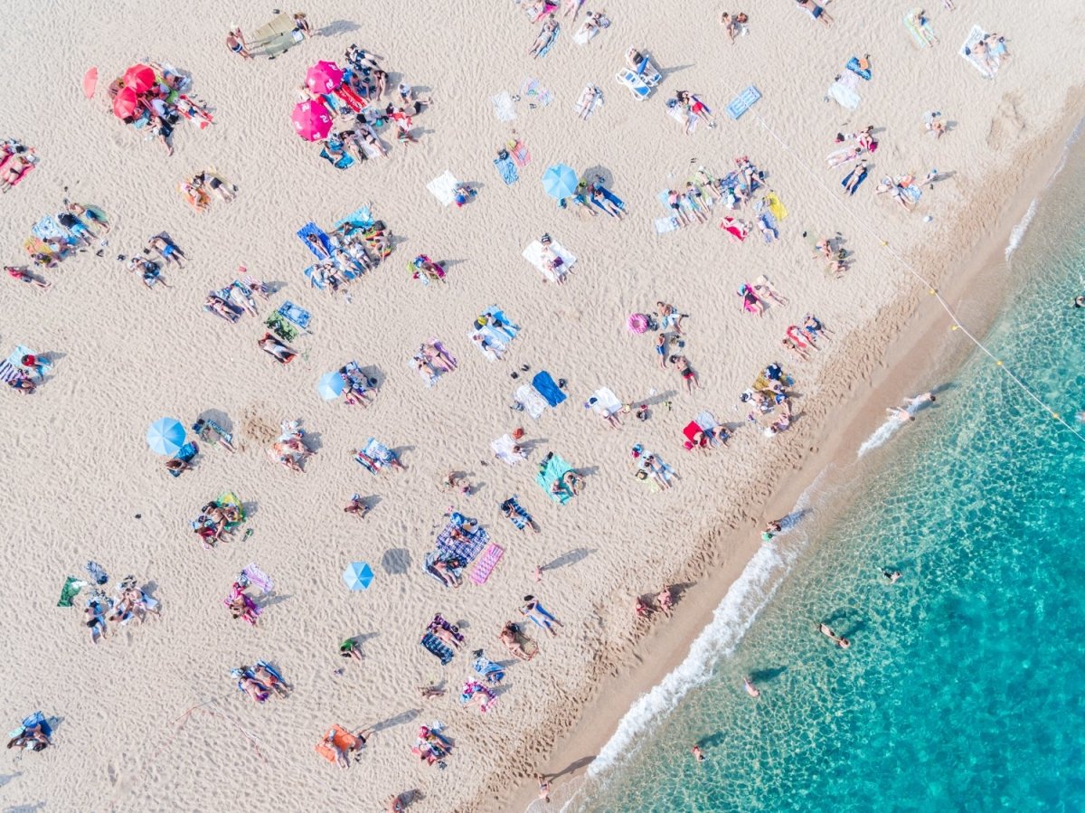 Aerial of people lying in the sun on the beach