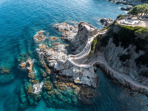 Stairway from above along blue water of Costa Brava