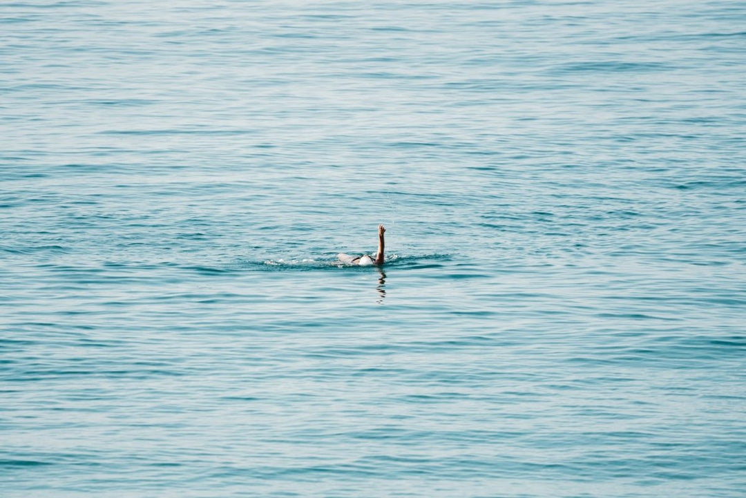 Woman swimming backstroke in the ocean in Costa Brava