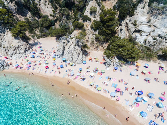 Colorful umbrellas on beach taken from air