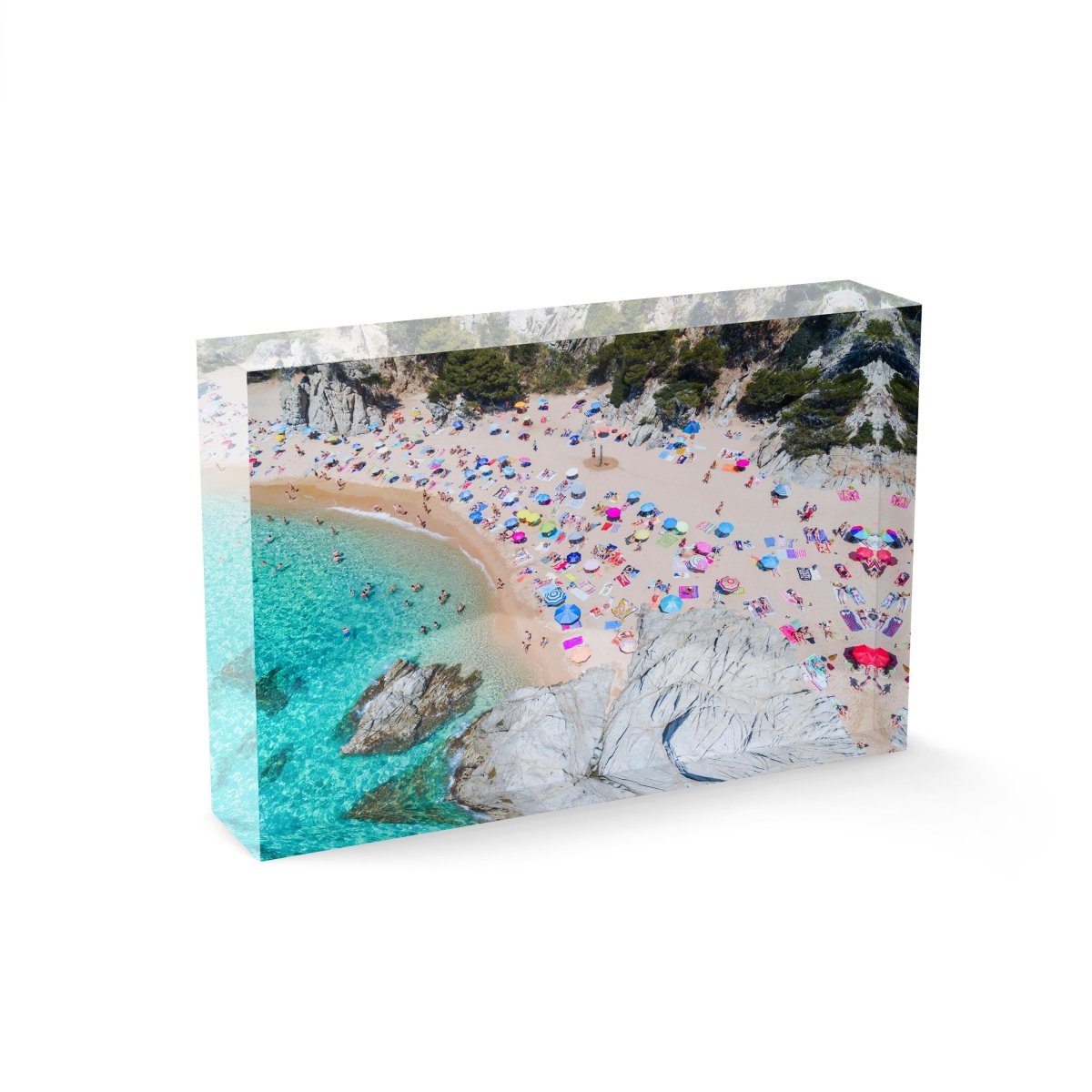 Colorful umbrellas and people lying on beach taken from the sky