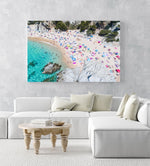 Colorful umbrellas and people lying on beach taken from the sky in an acrylic/perspex frame