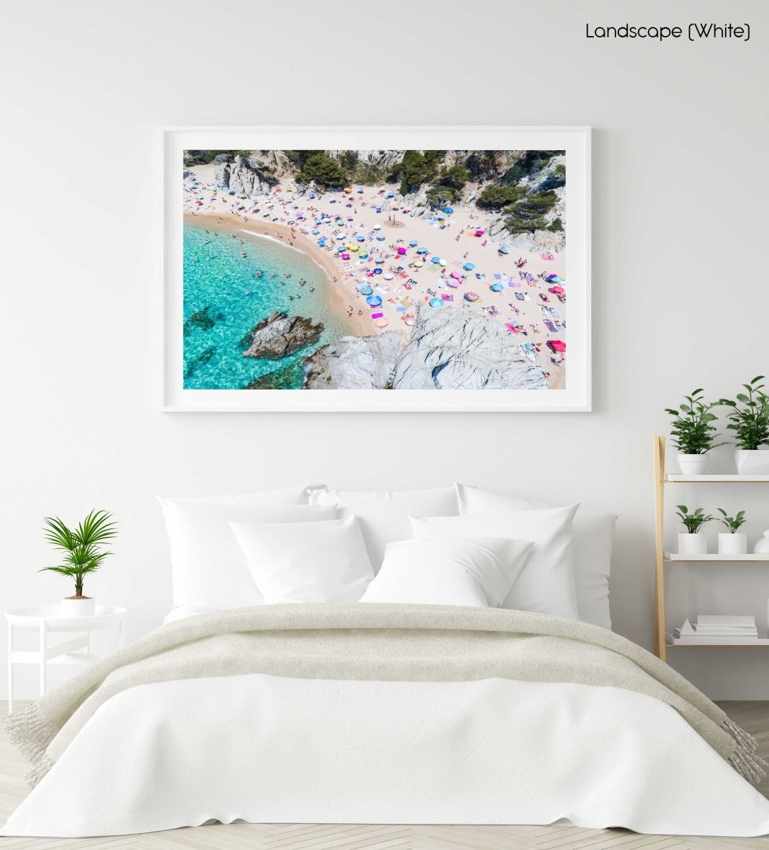 Colorful umbrellas and people lying on beach taken from the sky in a white fine art frame