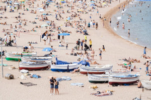 Boats and people beached along Tossa de Mar beach