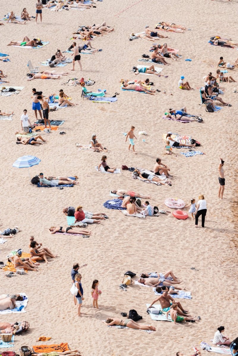 Lots of people lying on the sand in Tossa de Mar