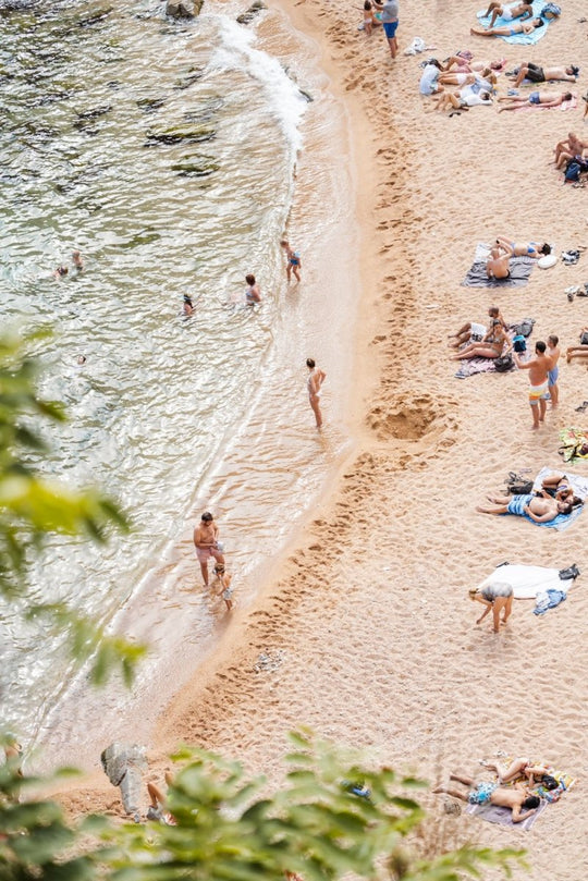 Playa Es Codolar beach goers and swimmers in water