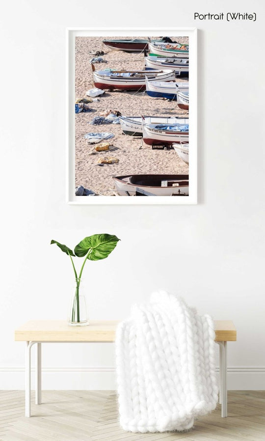 Wooden boats beached on the sand in a white fine art frame