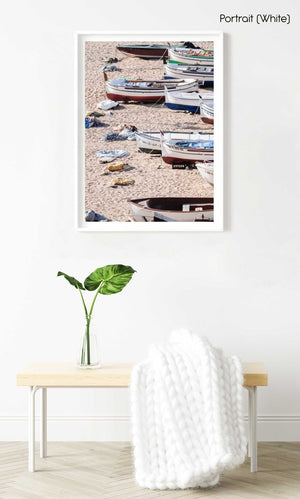 Wooden boats beached on the sand in a white fine art frame