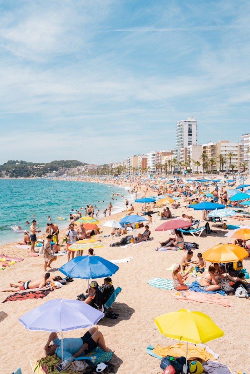 Very busy Lloret de Mar beach full of umbrellas and people