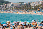 Crowds of people on either side of beaches at Lloret de Mar in a white fine art frame