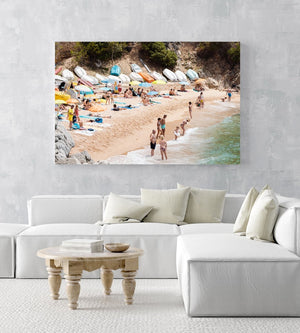Colorful boats, umbrellas and people lying on beach in an acrylic/perspex frame