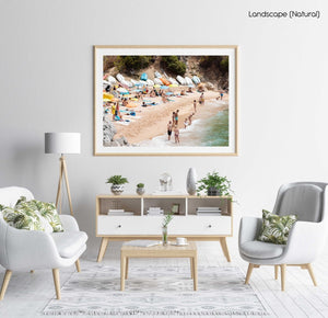 Colorful boats, umbrellas and people lying on beach in a natural fine art frame