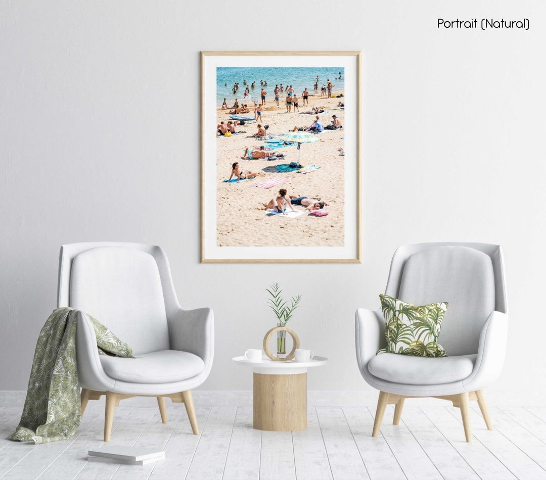 People tanning, swimmers and umbrellas at a beach in Cascais Portugal in a natural fine art frame