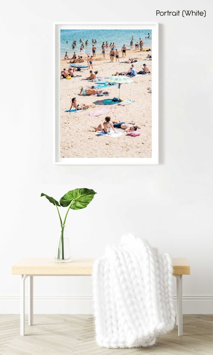 People tanning, swimmers and umbrellas at a beach in Cascais Portugal in a white fine art frame