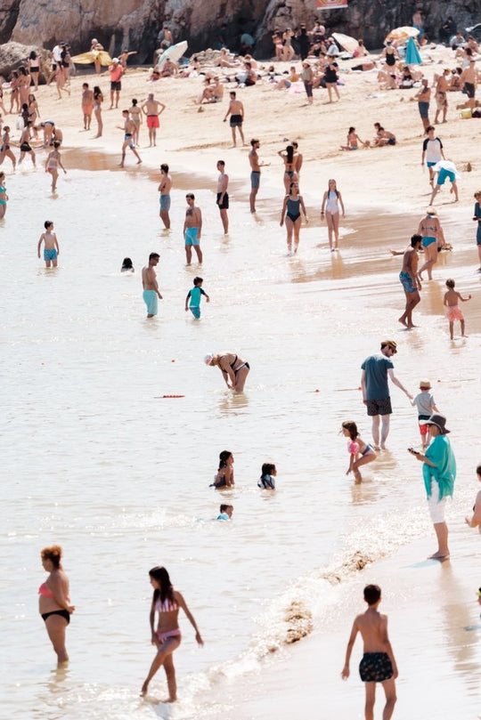 Swimmers and people tanning along Cascais coast