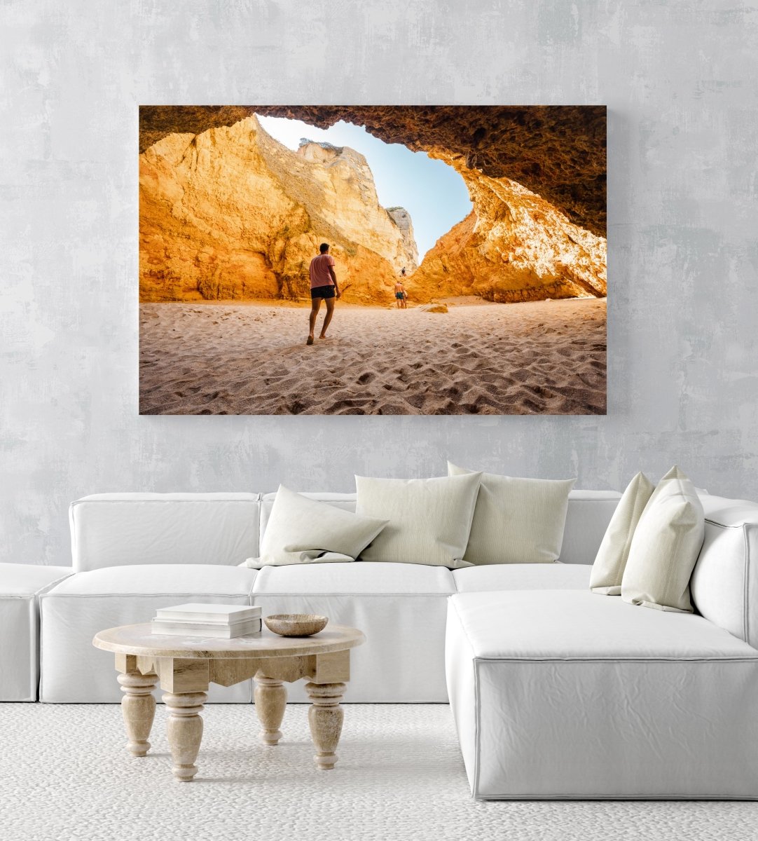 Man walking in a big yellow cave in Praia Dona Ana beach in Lagos in an acrylic/perspex frame