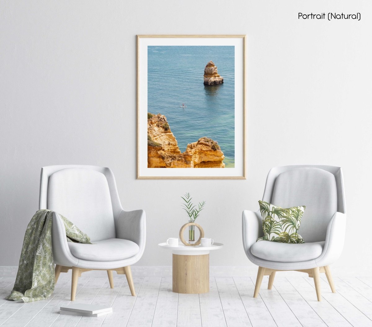 Woman on a SUP in the ocean along Lagos blue water and cliffs in a natural fine art frame