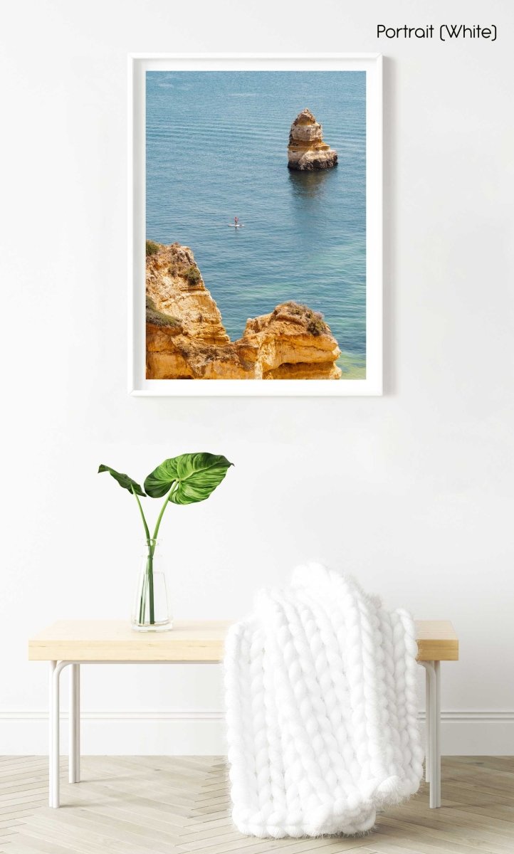 Woman on a SUP in the ocean along Lagos blue water and cliffs in a white fine art frame