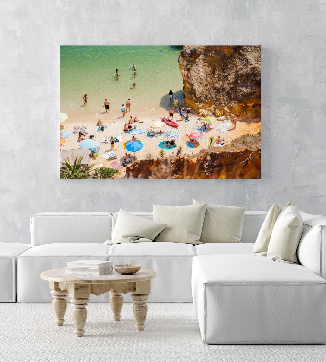 Crowd of people lying with umbrellas and swimming in green sea on Camilo beach in an acrylic/perspex frame