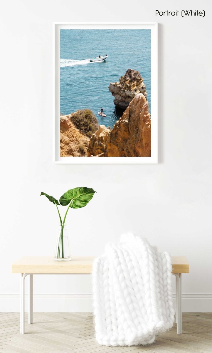 Two people on SUP watching boat drive past Lagos cliffs in a white fine art frame