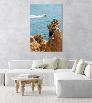 Two people on SUP watching boat drive past Lagos cliffs in an acrylic/perspex frame