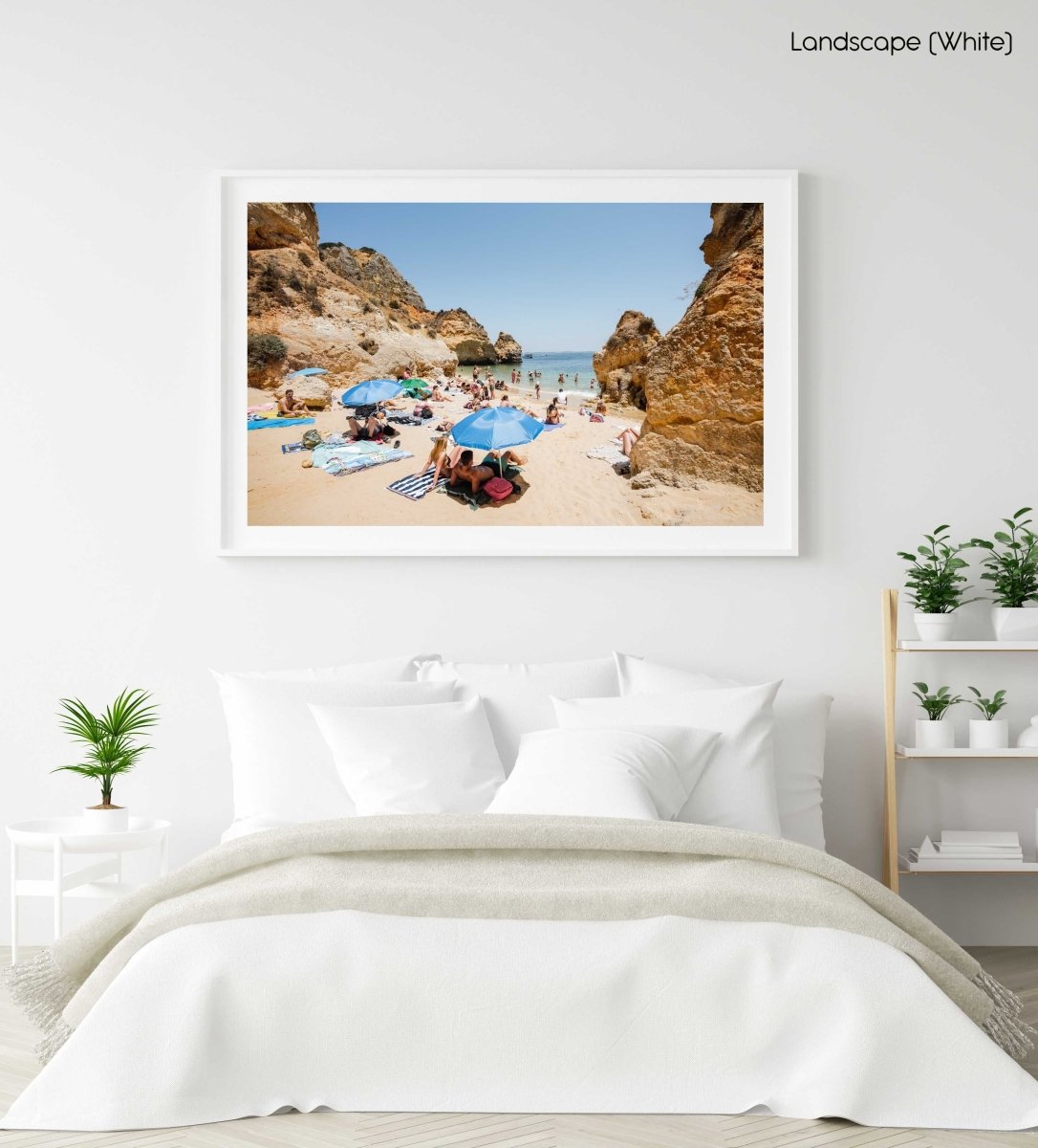 Blue umbrellas and people on Camilo beach Portugal in a white fine art frame