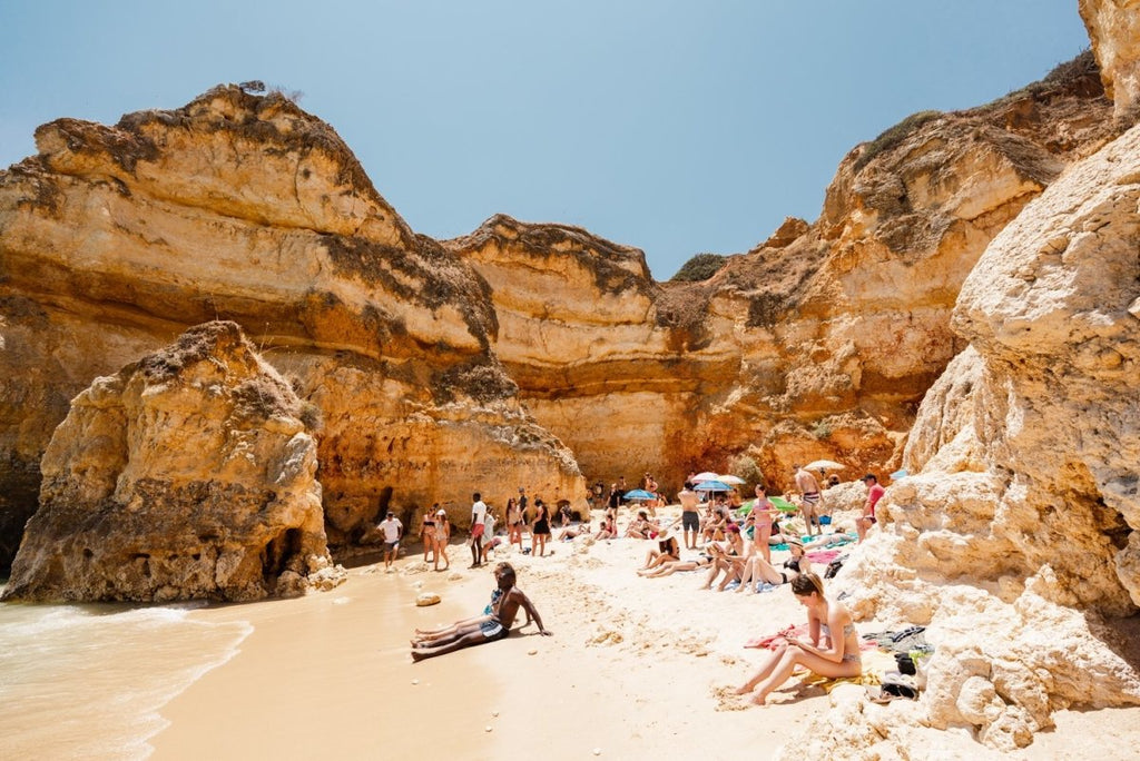 High cliffs overhanging beach where people lying under in June