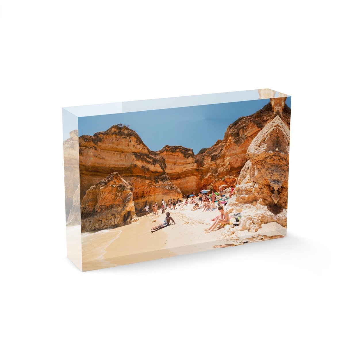 High cliffs overhanging beach where people lying under in June