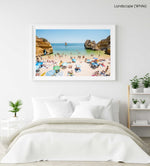 Busy Camilo beach with cliffs, people and calm green water in a white fine art frame
