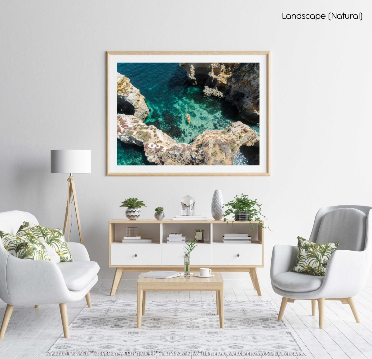 Aerial of two people paddling yellow kayak near Lagos caves in ocean in a natural fine art frame