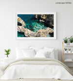 Aerial of two people paddling yellow kayak near Lagos caves in ocean in a white fine art frame