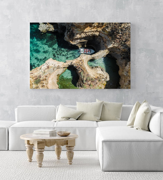 Aerial of a tour boat in caves along Ponta da Piedade in a white fine art frame