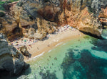 Aerial of clear water and cliffs at Camilo beach in Lagos