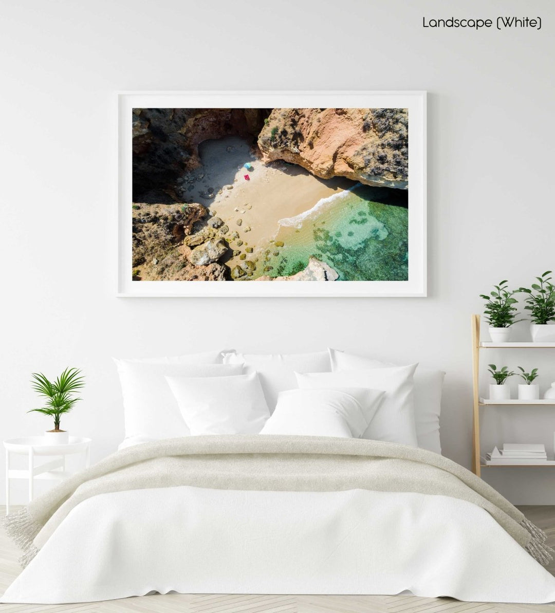 Woman lying with umbrella at cliffs on a secret beach in Lagos