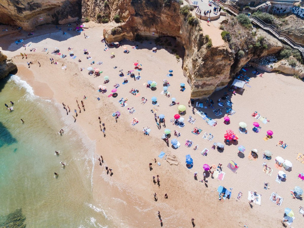Aerial view of Praia Dona Ana and people tanning