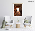 Golden orange light and footsteps through cave at Lagos in a natural fine art frame