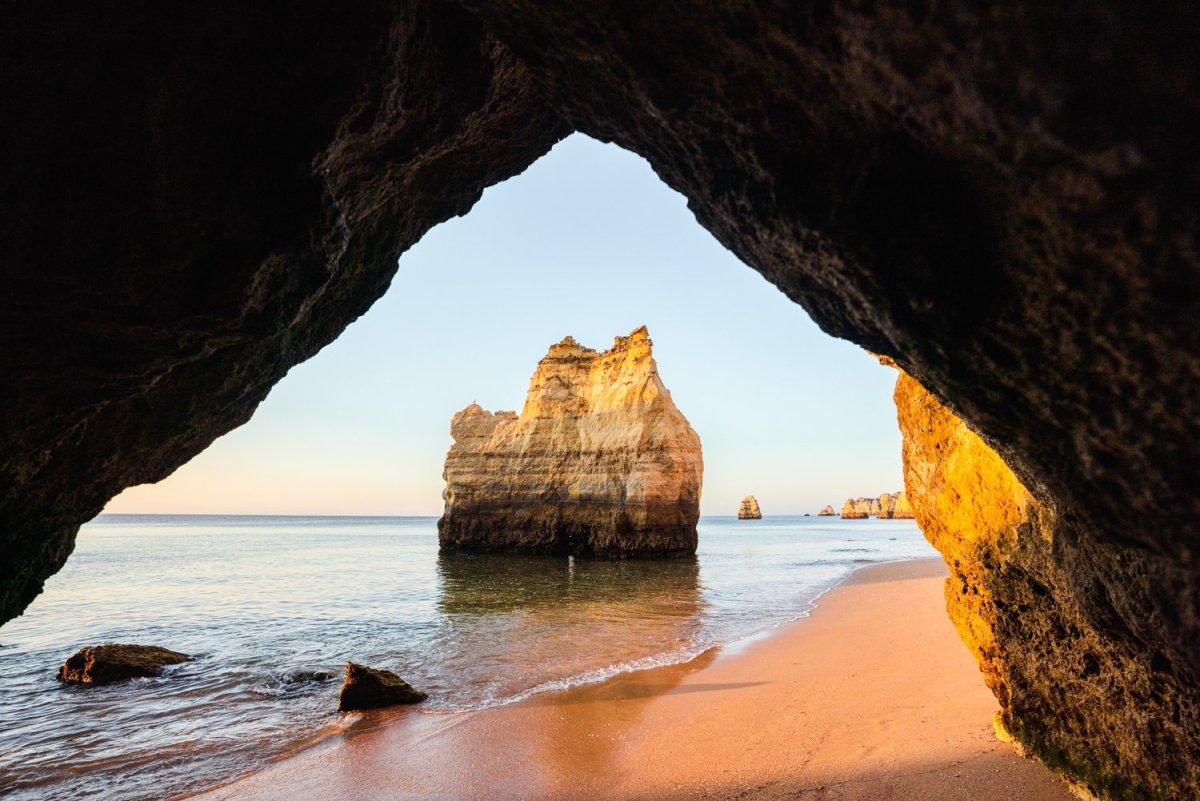 Inside a cave looking at cliffs along beach in Lagos