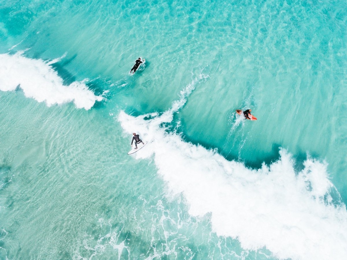 Surfers on a wave from above taken at Glen Beach, Cape Town