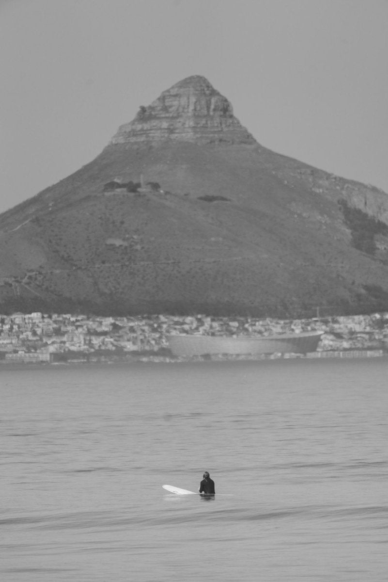 Blouberg surfer waiting for a wave beneath Lion's Head