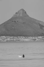 Blouberg surfer waiting for a wave beneath Lion's Head